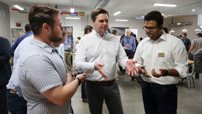 Author and venture capitalist J.D. Vance, center, spoke with Ben Douglas, left, and Ashok Seetharam, right, both of Toggle Health, as they demonstrated a wireless controller that is designed to allow doctors to quickly and safely access data during surgery. The were at the Startup Crawl event at Maker13 in Jeffersonville. Local inventors showcased their technology at the event.
May 11, 2018